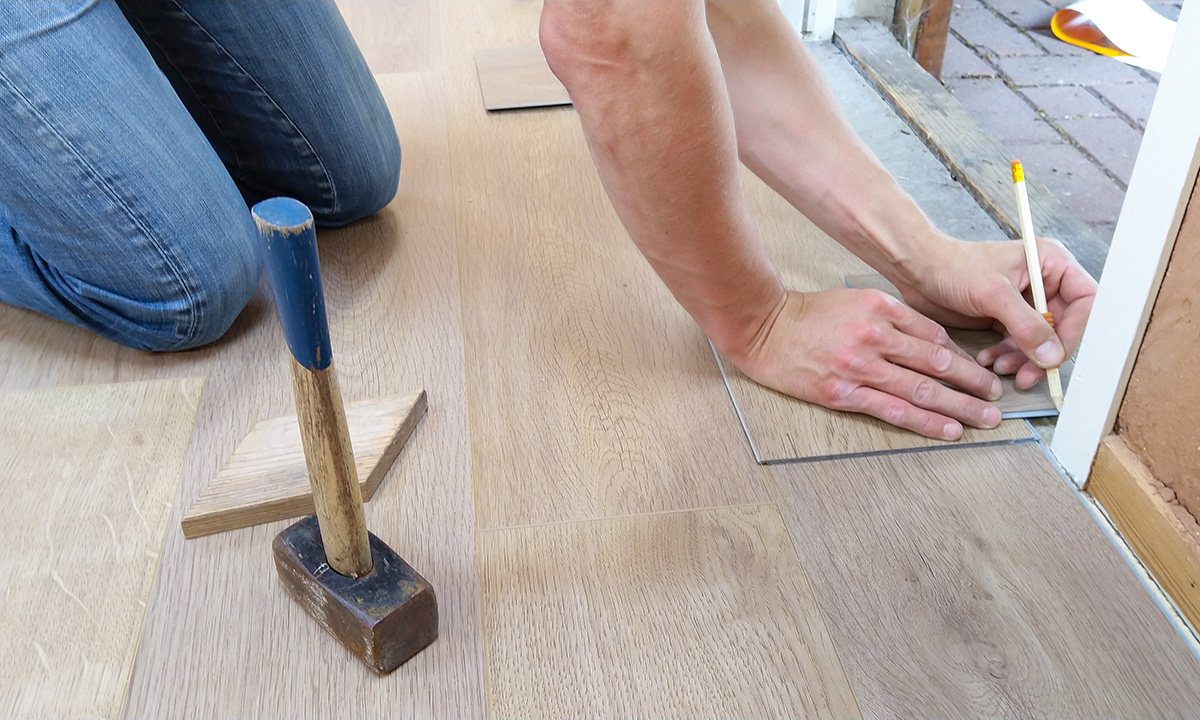 Man redoing the flooring in his property.