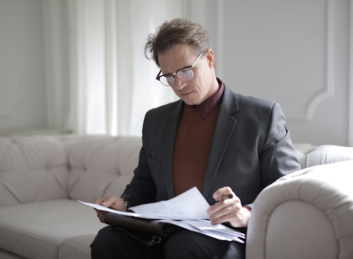A man studying his recent updates and reports from properties.