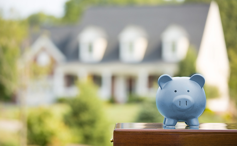 piggy bank sitting in front of a house