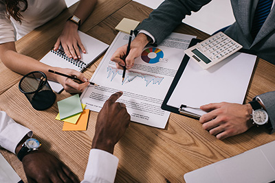 A group of three people completing paperwork