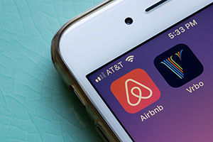 a iphone with the apps airbnb and vrbo on it