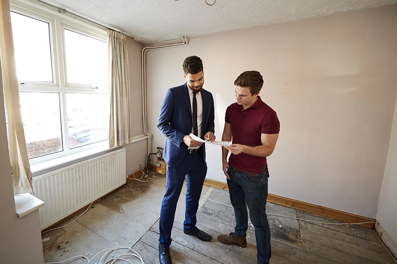 real estate wholesaler looking at a house 